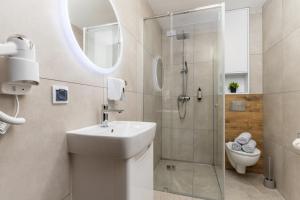 a bathroom with a shower and a sink and a toilet at ToTuLokum in Krakow +66 photos