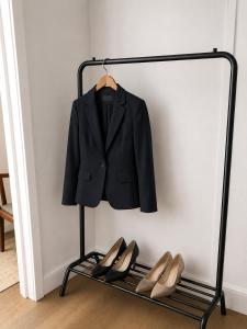 a suit and shoes on a rack next to a wall at Planet 9 in Warrington +5 photos