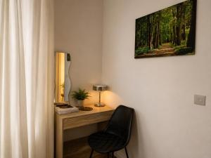 a room with a desk with a chair and a picture at Planet 9 in Warrington