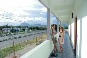 a man and a woman standing on the balcony of a building at Vetri Residency in Agastīswaram