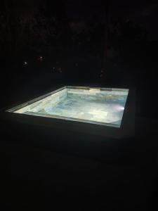 a large tub filled with water in a dark room at Habitation Pineau in Deshaies