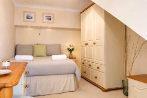 a small bedroom with a bed and a dresser at Eagles Nest - By Rowes Retreats in Falmouth +43 photos