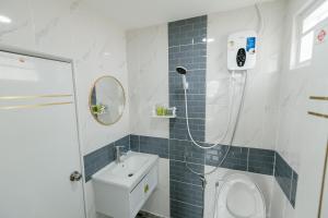 a bathroom with a sink and a toilet and a mirror at ศรีคำน่านรีสอร์ท in Ban Muang Chang Tai +37 photos