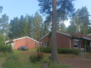 a house with a car parked in front of it at Half Way in Kalaniemi