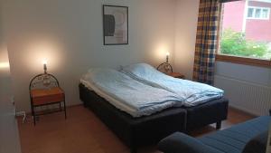 a bedroom with a bed and a window and a couch at Half Way in Kalaniemi
