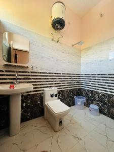 a bathroom with a toilet and a sink at Nirvana Homestay in Chamba +12 photos