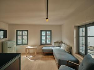 a living room with a couch and some windows at Stuveles Apartments in Brixen