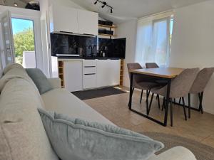 a living room and kitchen with a couch and a table at Studios Ilic in Seline +34 photos