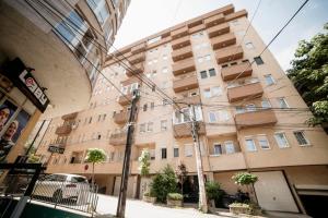 a tallartment building with a street in front of it at Estilo Apartments in Prishtinë