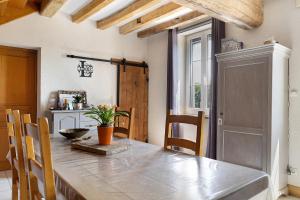 a kitchen with a wooden table and a dining room at Lorali - Chambre d'Hôtes in Gohier