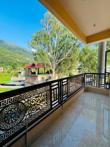 a balcony with a wrought iron fence and a view at Nirvana Homestay in Chamba