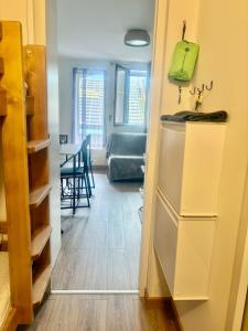 a kitchen and dining room with a refrigerator and a table at Refuge 1000, studio cosy in Mijoux