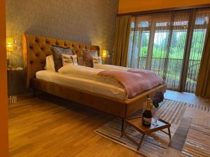 a bedroom with a large bed with a large window at Newly renovated Boutique Hotel Giulia Slow Residence in Velden am Wörthersee