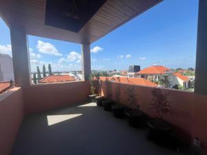 a balcony with potted plants and a view of a city at Hakon Canggu Boutique Hostel in Canggu