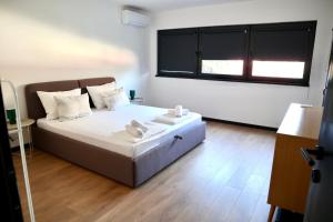 a bedroom with a bed and a large window at Villa Vincek in Mostar +28 photos