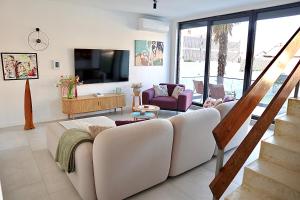 a living room with a couch and a tv at Villa Vincek in Mostar