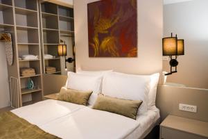 a bedroom with a white bed with pillows at Galathea House in Kotor