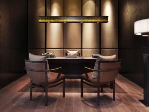 a dining room with a table and two chairs at The Puli Hotel And Spa in Shanghai