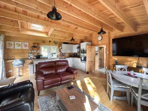 a living room with a couch and a table in a cabin at The Cabin in Sevenoaks