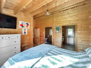 a bedroom with a bed in a wooden cabin at The Cabin in Sevenoaks +16 photos