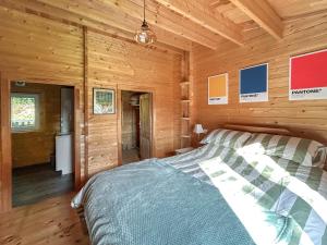 a bedroom with a bed in a wooden cabin at The Cabin in Sevenoaks