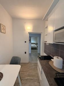 a kitchen with a counter top and a stove top oven at Modern Cozy Apartment Lola in Doboj