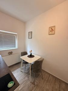 a small dining room with a table and chairs at Modern Cozy Apartment Lola in Doboj