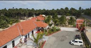 an aerial view of a house with a car parked in front at Adam's Palm Resort in Talaimannar