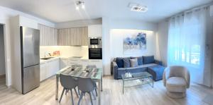 a living room with a blue couch and a kitchen at Casa Do Ma Ni, Sitia in Sitia