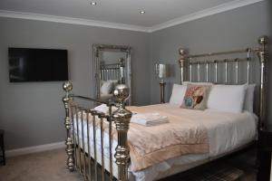 a bedroom with a bed and a tv on the wall at The Seacliffe - Whitby in Whitby