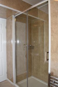 a shower with a glass door in a bathroom at The Seacliffe - Whitby in Whitby