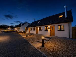 a building with lights in front of it at night at Hawthorn Cottage in Tenby