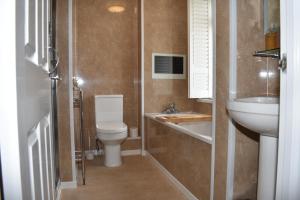 a small bathroom with a toilet and a sink at The Seacliffe - Whitby in Whitby