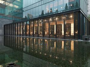 a large glass building with lights on the side of it at The Puli Hotel And Spa in Shanghai