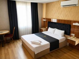 a hotel room with a bed with towels on it at Grand Mardin Hotel in Mersin