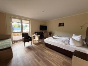 a bedroom with a bed and a table and chairs at Alte Schleiferei in Breitenbrunn