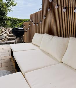 two white couches on a patio with a grill at Boutique Home Bad Iburg in Bad Iburg +28 photos