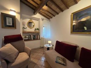 a living room with a couch and a chair at Adagio Umbro in Sustrico Di Spoleto