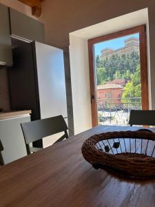 a kitchen with a table with a view of a balcony at Il Nespolo in Celano