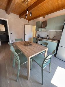 a kitchen with a wooden table and chairs at Il Nespolo in Celano