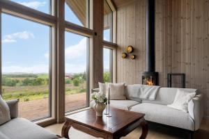 a living room with a couch and a fireplace at Hoven Lodge in Vik