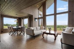 a living room with a couch and chairs and a table at Hoven Lodge in Vik