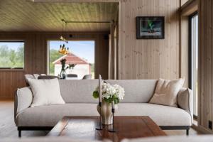 a living room with a couch and a table with flowers at Hoven Lodge in Vik