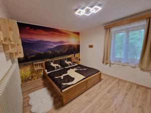 a bedroom with a bed with a painting on the wall at Ferienhaus Teichalm in Lantsch