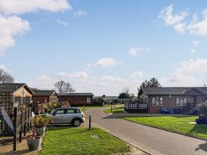 a car parked in the driveway of a house at Staying Inn in West Mersea