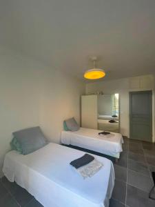 a room with two beds and a yellow light at Appartement proche gare in Nice