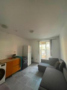 a kitchen and living room with a couch and a stove at Appartement proche gare in Nice