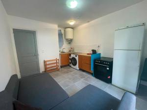 a small kitchen with a refrigerator and a dishwasher at Appartement proche gare in Nice