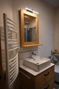 a bathroom with a sink and a mirror at Petit balcon du lac in Lathuile +21 photos