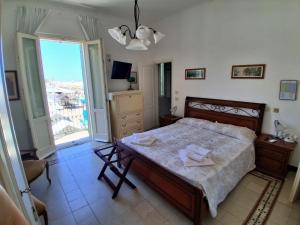a bedroom with a bed and a large window at Albergo Regina in Senigallia
